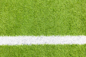 White stripe on the green soccer field from top view