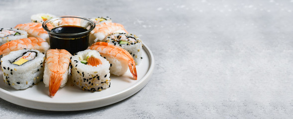 food delivery set of sushi and rolls with salmon and shrimp on the light background, selective focus image. service food order online. 