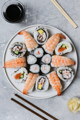 food delivery set of sushi and rolls with salmon and shrimp on the light background, selective focus image. service food order online. 