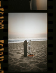 Skateboards at the beach in a film strip - obrazy, fototapety, plakaty