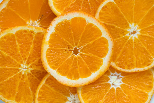 Closeup of sliced juicy oranges textured background