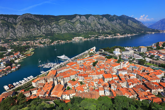 Aerial beautiful View of Kotor bay. Cruise ship docked in beautiful summer day. View of kotor old town from Lovcen mountain in Kotor, Montenegro. Kotor is part of the unesco world.