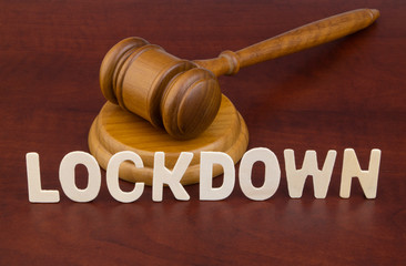 Judge gavel with word lockdown. Laws and lockdown concept.