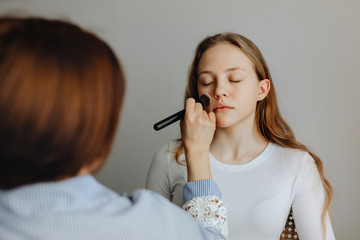 Young girl getting makeup done