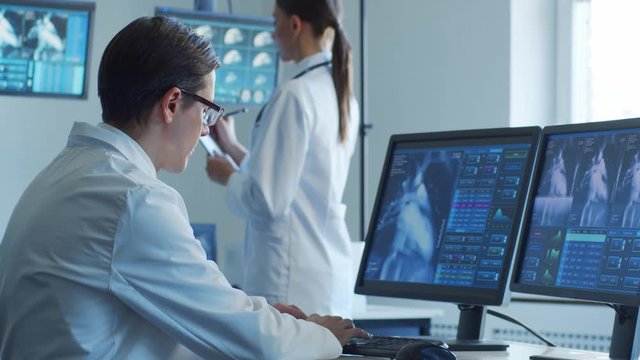 Medical doctors working in hospital office making computer research. Medicine, healthcare and technology concept.