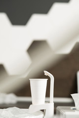 A Cup for rinsing teeth after a dental procedure against a brown wall in modern dentistry