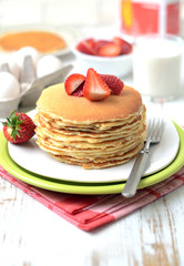 freshly prepared pancakes with strawberries