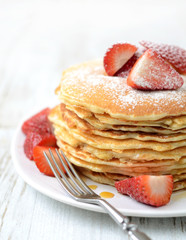 freshly prepared pancakes with strawberries