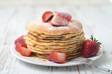 freshly prepared pancakes with strawberries