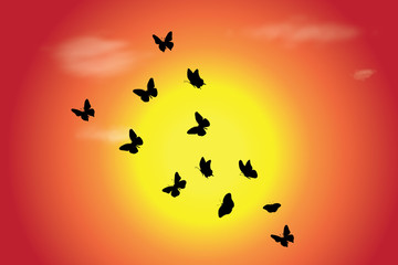 Vector silhouette of flying butterflies at sunset. Symbol of nature.