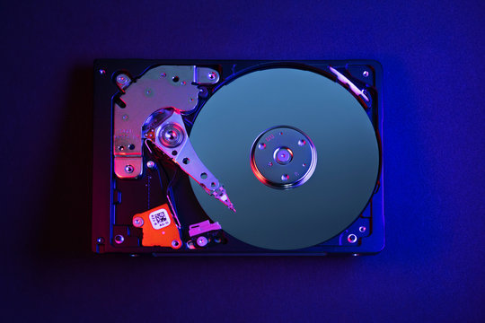 Computer hard disk drive HDD photo in cyberpunk styles. Red-blue background