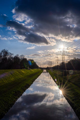 Reflections of sun rays in Emscher river, North Rhine-Westphalia