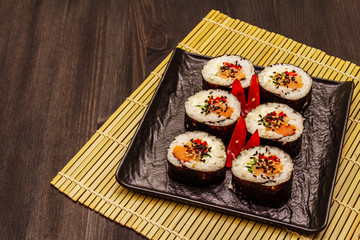 Korean roll Gimbap(kimbob). Steamed white rice (bap) and various other ingredients. Trendy black background