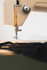 vintage sewing machine closeup detail needle black thread fabric