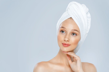 Beautiful woman in a white towel on a head.