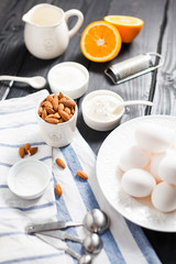 almonds in a white porcelain Cup on the table with baking ingredients