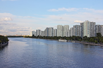 Moscow, Russia, Moscow river and Modern residential buildings on embankment in Nagatinsky zaton area on blue sky background at summer day, Kolomenskaya district panoramic cityscape