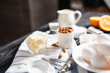 almonds in a white porcelain Cup on the table with baking ingredients