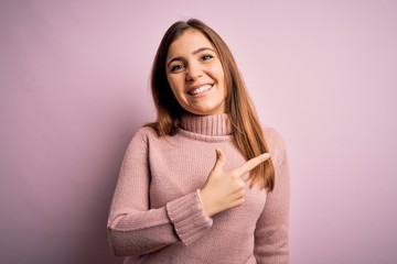 Obraz premium Beautiful young woman wearing turtleneck sweater over pink isolated background cheerful with a smile of face pointing with hand and finger up to the side with happy and natural expression on face