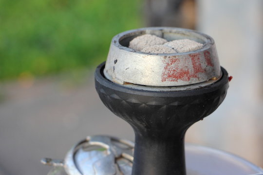 Portable hookah with kalian coals close up
