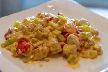 Curry Chicken with Cream, Mustard and Julienne Vegetables served with Plate.