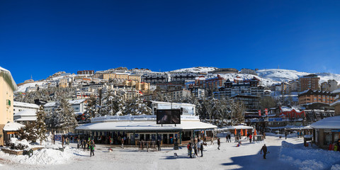 Panoramic view of the main square of Pradollano in Sierra Nevada, Granada. A sunny day after a...