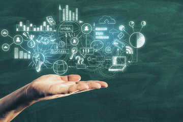 Hand holding drawing business concept on blackboard.