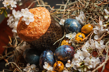 easter eggs and traditional easter muffin in a nest