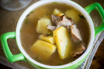 hot pea soup with meat and vegetables in a plate