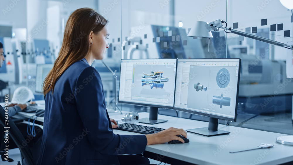 Poster Portrait of Young and Confident Industrial Engineer Working on Computer, on Screen CAD Software Showing New Generation Electric Engine. Industrial Factory with High-Tech CNC Machinery.
