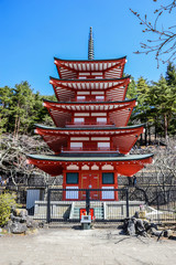 Red wooden pagoda near the Fuji mountain in Japan