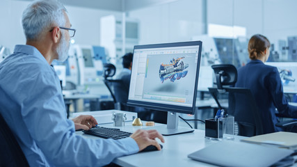 Modern Industrial Factory: Team of Mechanical Engineers Working on Computers, Using Newest High-Tech Devices Like Virtual Reality Headsets to Design Best Engines. 3D Graphics in Contemporary Industry