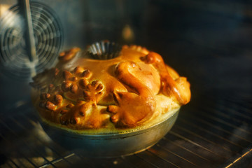 Traditional Russian wedding bread is baked in the oven. Korovai