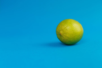 Green lemon-lime on a blue background. Space for text