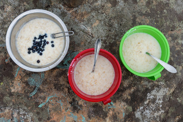 Nutrition breakfast of tourist hikers: porridge with blueberries in Carpathian mountain
