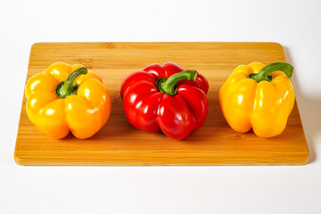 Sweet peppers yellow and red on a white background