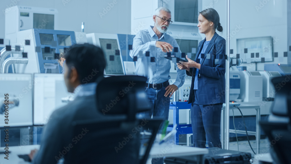 Leinwandbilder modern factory: female engineer, male project manager standing in high tech development facility, ta