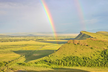 bright double rainbow over green hills, Khakassia