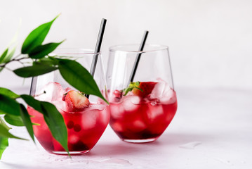 Glasses of Tasty Cranberry Cocktail with Ice Cubes on light Gray Background Alcoholic Drink Straws Horizontal Copy Space