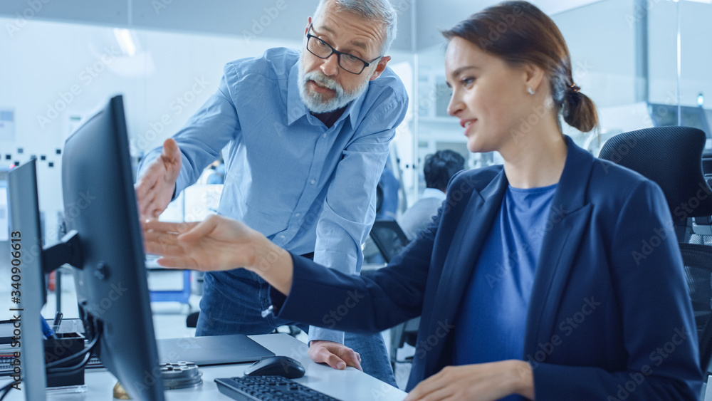 Aufkleber Modern Factory Office: Project Manager Supervisor Talk to a Female Engineer Working on Computer. Team of Professionals Solving Heavy Industry Problems, Having Discussion, Pointing at Display 