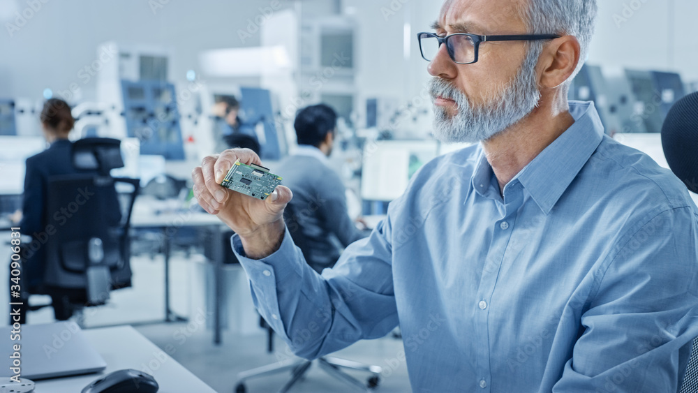 Aufkleber Electronics Design Factory Office: Electrical Engineer Working on Computers, using CAD Software to Develop Microchips, Semiconductor, Telecommunications Equipment. Manufacturing Processors