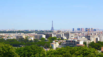 Paris, France - August 26, 2019: Paris from above showcasing the capital city's rooftops, the Eiffel Tower, Paris tree-lined avenues with their haussmannian buildings and Montparnasse tower. 16th