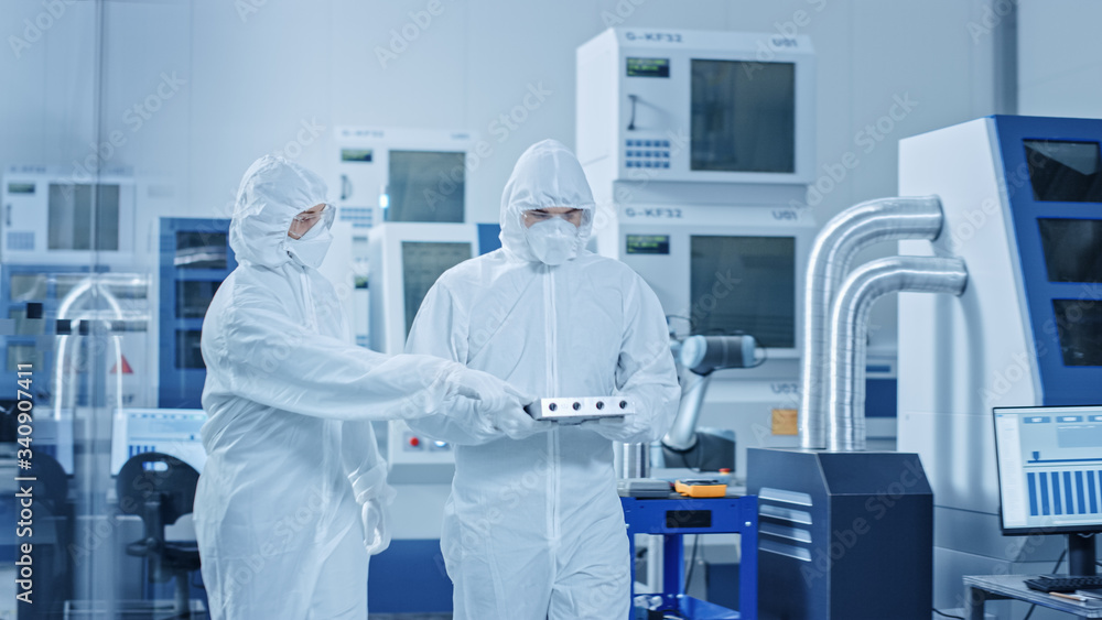 Poster sterile modern factory: professionals in coveralls, masks walk through workshop and talk. medical el