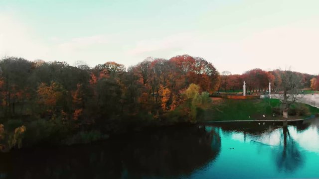 Vigeland park view from water to over the trees in oslo, norway, aerial