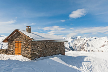 Isolated mountain hut house in the snow