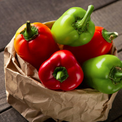 Organic fresh paprika in zero waste paper sack on wood