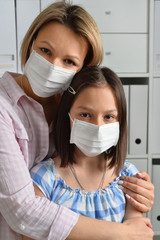 Portrait of little girl and mom wearing facial masls