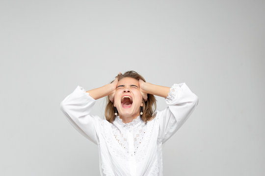 Very angry woman. Frustration. Frustrated and stressed young businesswoman. Beautiful young mixed race asian / caucasian woman isolated on white background.