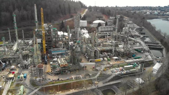 A aerial view of an oil refinery in Burrard Inlet with a view of downtown Vancouver, Canada, in the background.