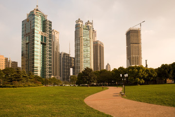 Obraz premium Shanghai, China - Skyline of modern office buildings at Lujiazui Financial district from Central Greenfield in Pudong.